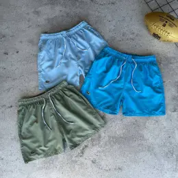 Плавальні шорти Lacoste з принтом при контакті з водою