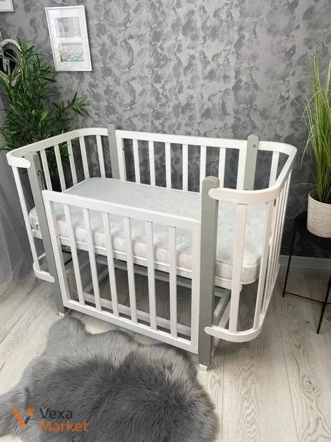 Дитяче ліжечко з маятниковим механізмом з натурального дерева Бук